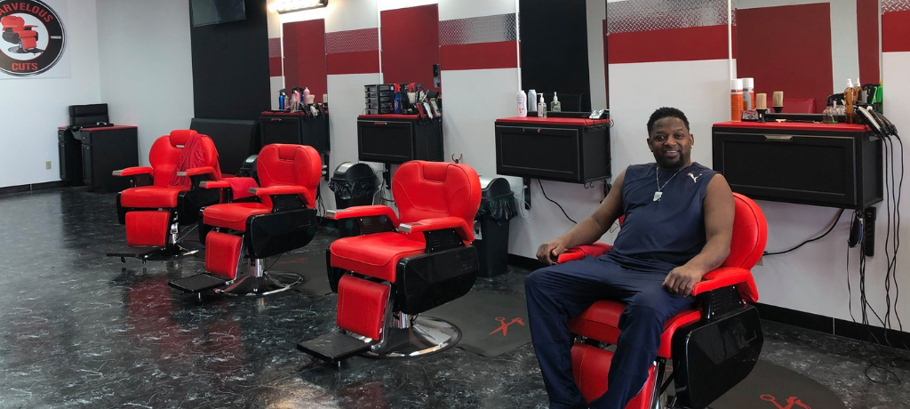 Man in a red chair in a barbershop